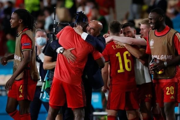 Belgium's Spanish coach Roberto Martinez celebrates their victory with teammates at the end of the UEFA EURO 2020 round of 16 football match between...