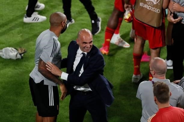 Belgium's Spanish coach Roberto Martinez celebrates with assistant coach Thierry Henry during the UEFA EURO 2020 round of 16 football match between...