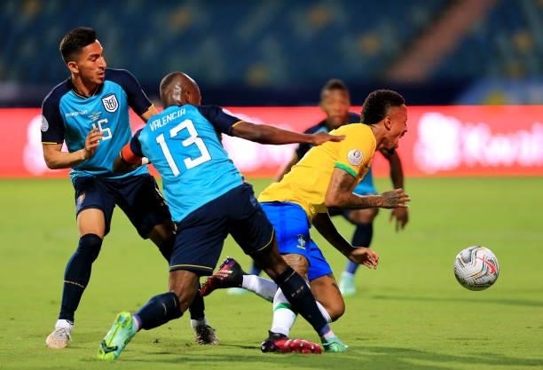 Eder Militao of Brazil competes for the ball with Enner Valencia and Angel Mena of Ecuador during a group B match between Brazil and Ecuador as part...