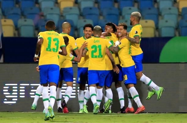 Eder Militao of Brazil celebrates with teammates after scoring the first goal of his team during the match between Brazil and Ecuador as part of...
