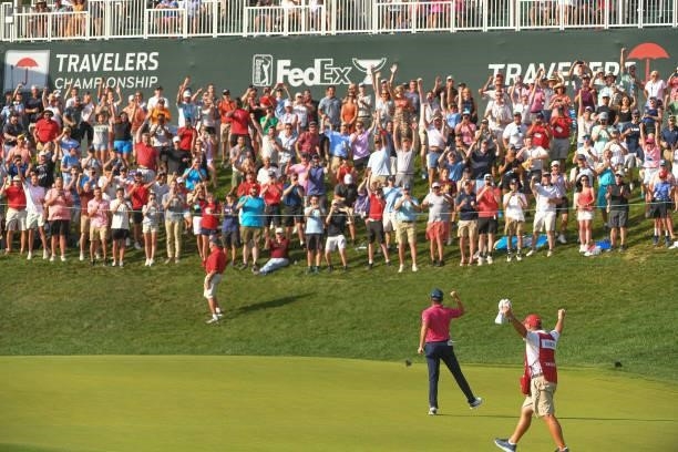 Kramer Hickok fist pumps while making a putt to tie the lead on the 18th green during the final round of the Travelers Championship at TPC River...