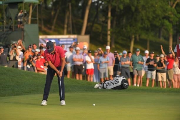 Kramer Hickok putts on the 17th green during the fifth playoff hole during the final round of the Travelers Championship at TPC River Highlands on...
