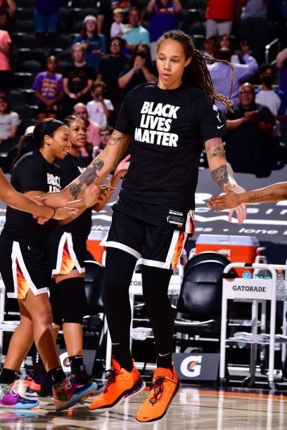 Brittney Griner of the Phoenix Mercury high fives her teammates before the game against the Los Angeles Sparks on June 27, 2021 at Phoenix Suns Arena...