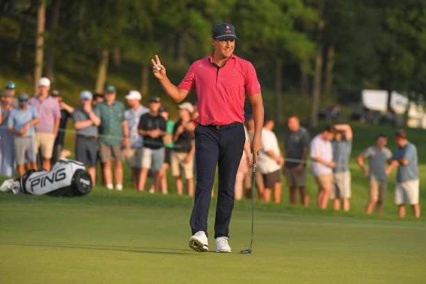 Kramer Hickok waves to fans on the 17th green during the fifth playoff hole during the final round of the Travelers Championship at TPC River...