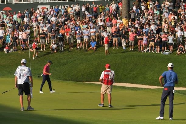 Kramer Hickok fist pumps while making a putt to force a second playoff hole on the 18th green during the final round of the Travelers Championship at...