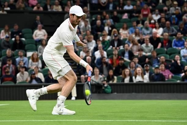 Britain's Andy Murray returns against Georgia's Nikoloz Basilashvili during their men's singles first round match on the first day of the 2021...