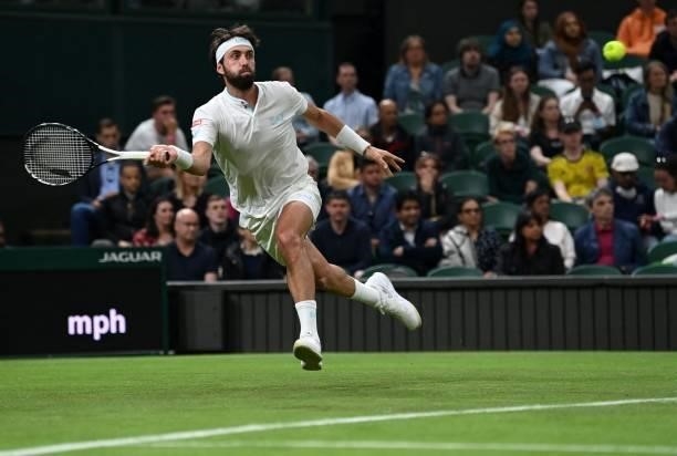 Georgia's Nikoloz Basilashvili returns against Britain's Andy Murray during their men's singles first round match on the first day of the 2021...