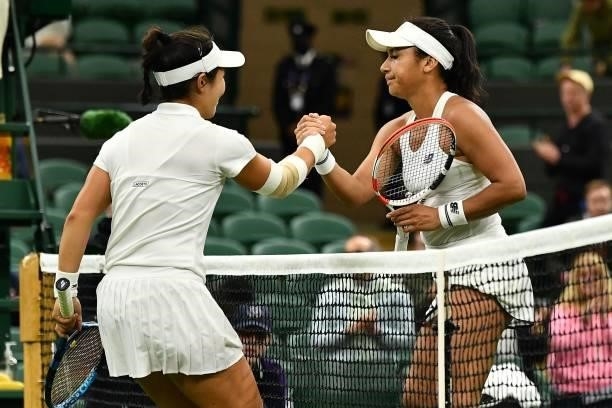 Player Kristie Ahn shakes hands with Britain's Heather Watson after winning their women's singles first round match of the 2021 Wimbledon...