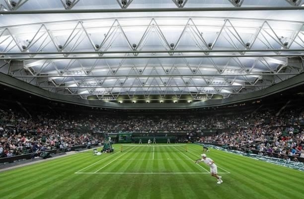 Britain's Andy Murray plays against Georgia's Nikoloz Basilashvili in their men's singles first round match on the first day of the 2021 Wimbledon...