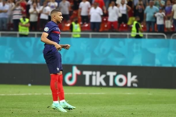 France's forward Kylian Mbappe reacts after missing a penalty during the UEFA EURO 2020 round of 16 football match between France and Switzerland at...