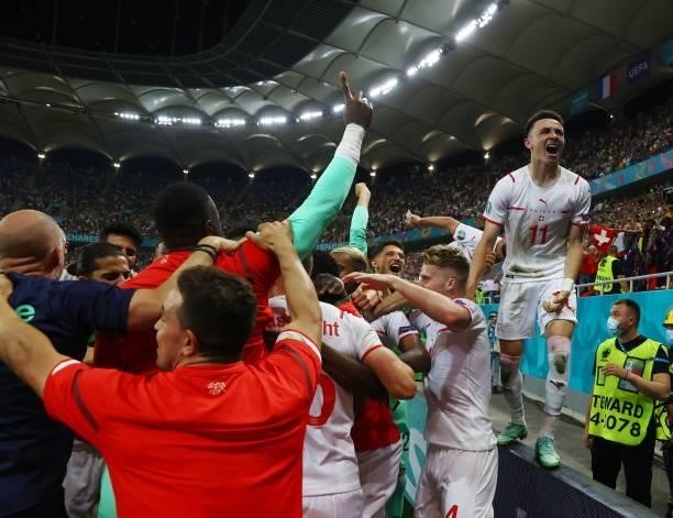 Switzerland's players celebrate their win in the UEFA EURO 2020 round of 16 football match between France and Switzerland at the National Arena in...