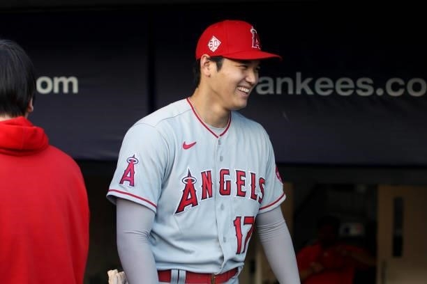 Shohei Ohtani of the Los Angeles Angels looks on from the dugout before the game between the Los Angeles Angels and the New York Yankees at Yankee...