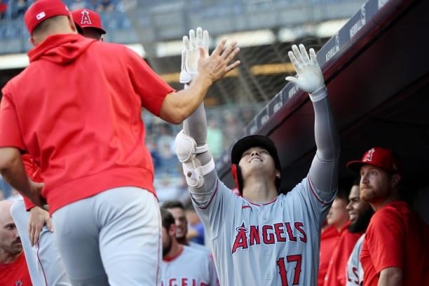 Shohei Ohtani of the Los Angeles Angels celebrates in the dugout after hitting a home run during the game between the Los Angeles Angels and the New...