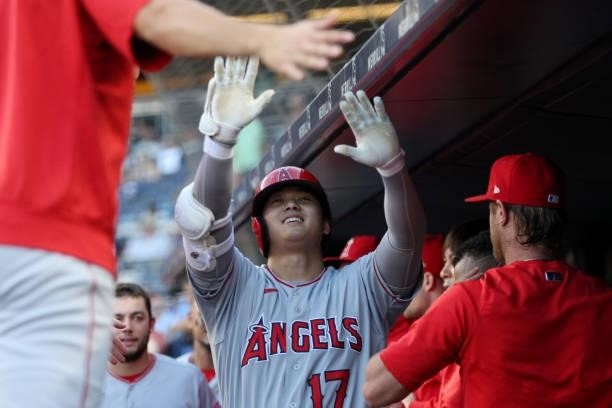 Shohei Ohtani of the Los Angeles Angels celebrates in the dugout after hitting a home run during the game between the Los Angeles Angels and the New...