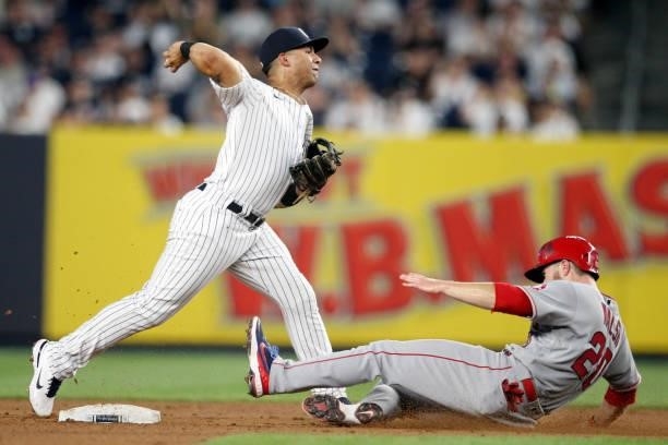 Gleyber Torres of the New York Yankees throws over Jared Walsh of the Los Angeles Angels during the game at Yankee Stadium on Monday, June 28, 2021...