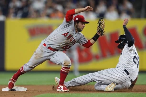 David Fletcher of the Los Angeles Angels attempts to make a play on Gio Urshela of the New York Yankees as he slides into second base during the game...