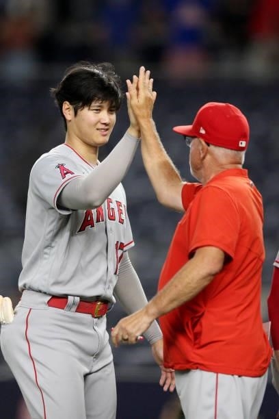 Shohei Ohtani and Manager Joe Maddon of the Los Angeles Angels celebrate after the Angels defeated the New York Yankees at Yankee Stadium on Monday,...