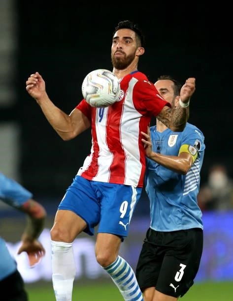 Gabriel Avalos of Paraguay controls the ball against Diego Godin of Uruguay during the match between Uruguay and Paraguay as part of Conmebol Copa...
