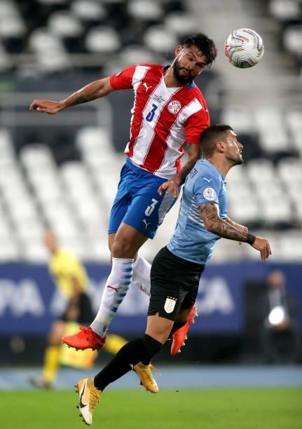 Omar Alderete of Paraguay heads the ball against Giorgian De Arrascaeta of Uruguay during the match between Uruguay and Paraguay as part of Conmebol...