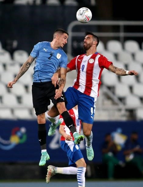 Gabriel Avalos of Paraguay heads the ball against Jose Gimenez of Uruguay during the match between Uruguay and Paraguay as part of Conmebol Copa...