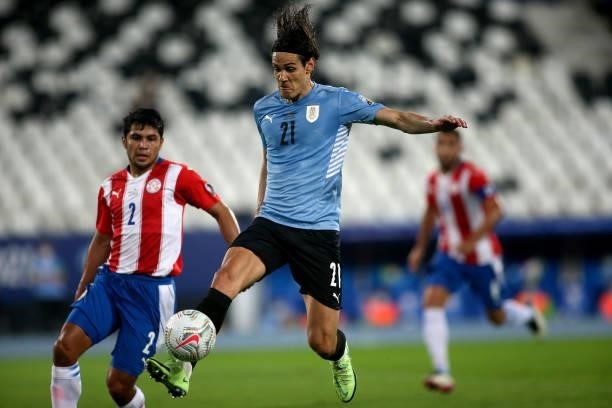 Edinson Cavani of Uruguay competes for the ball with Robert Rojas of Paraguay during the match between Uruguay and Paraguay as part of Conmebol Copa...