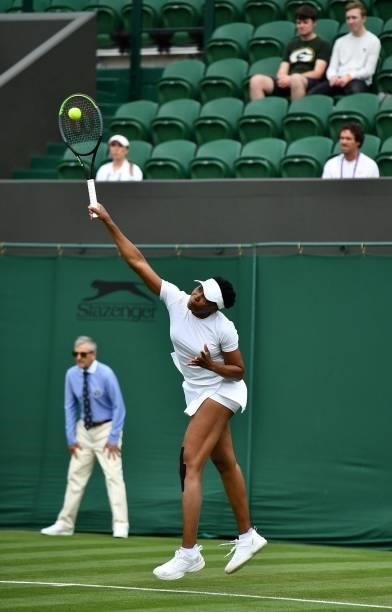 Player Venus Williams serves against Romania's Mihaela Buzarnescu during their women's singles first round match on the second day of the 2021...
