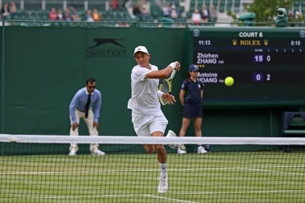 France's Antoine Hoang returns against China's Zhizhen Zhang during their men's singles first round match on the second day of the 2021 Wimbledon...