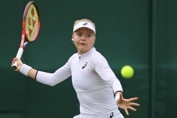 Britain's Harriet Dart returns to Belgium's Elise Mertens during their women's singles first round match on the second day of the 2021 Wimbledon...