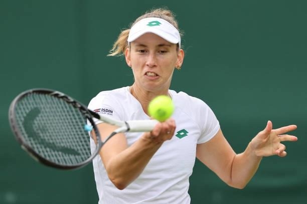 Belgium's Elise Mertens returns to Britain's Harriet Dart during their women's singles first round match on the second day of the 2021 Wimbledon...