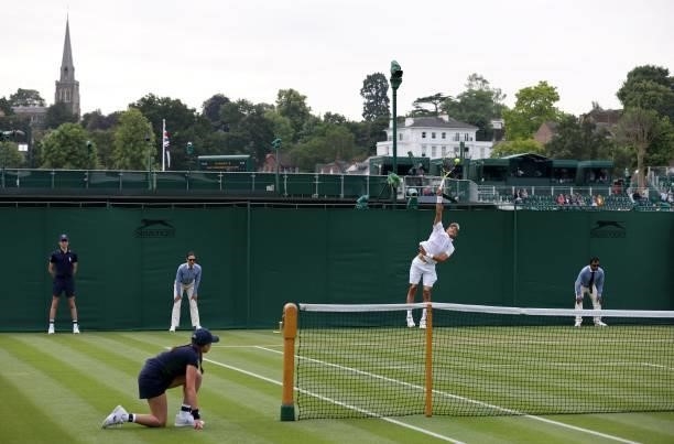 France's Antoine Hoang serves against China's Zhizhen Zhang during their men's singles first round match on the second day of the 2021 Wimbledon...