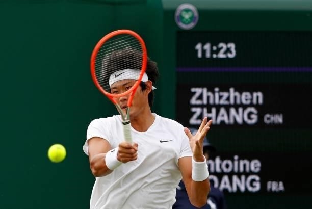 China's Zhizhen Zhang returns against France's Antoine Hoang during their men's singles first round match on the second day of the 2021 Wimbledon...