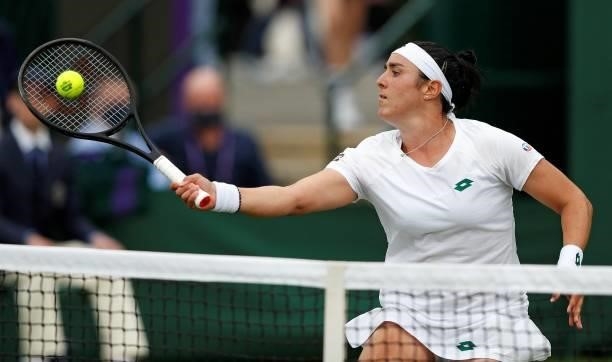 Tunisia's Ons Jabeur returns against Sweden's Rebecca Peterson during their women's singles first round match on the second day of the 2021 Wimbledon...
