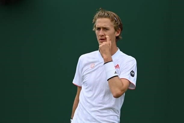Player Sebastian Korda reacts while playing Australia's Alex de Minaur during their men's singles first round match on the second day of the 2021...