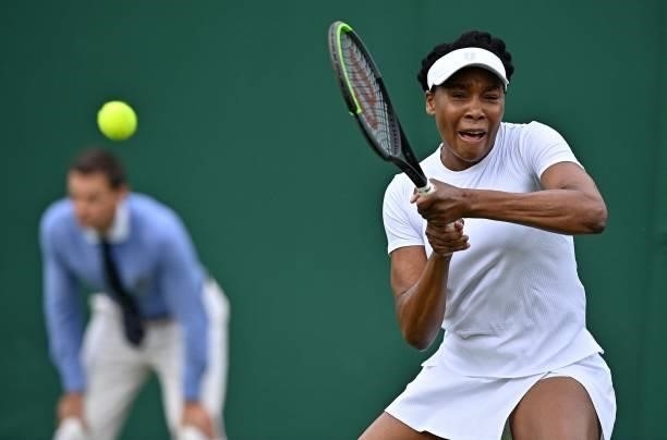 Player Venus Williams returns against Romania's Mihaela Buzarnescu during their women's singles first round match on the second day of the 2021...