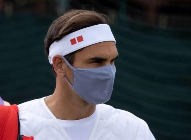 Switzerland's Roger Federer, wearing a face covering to combat the spread of coronavirus, arrives at the Aorangi Practice Practice Courts on the...
