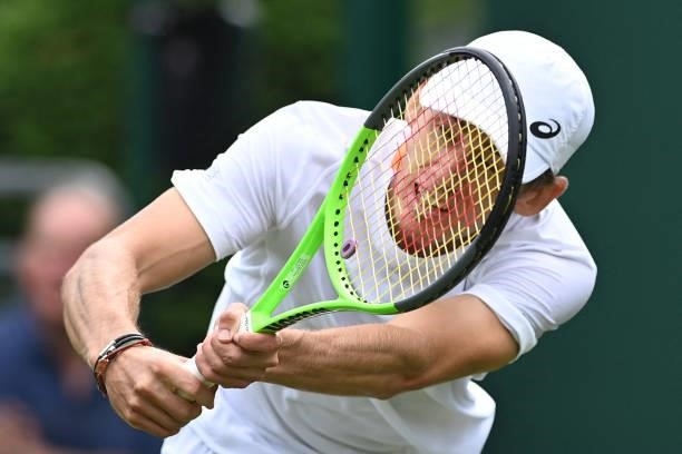 Australia's Alex de Minaur returns to US player Sebastian Korda during their men's singles first round match on the second day of the 2021 Wimbledon...