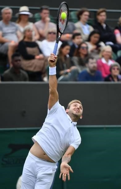 Britain's Daniel Evans serves to Spain's Feliciano Lopez during their men's singles first round match on the second day of the 2021 Wimbledon...
