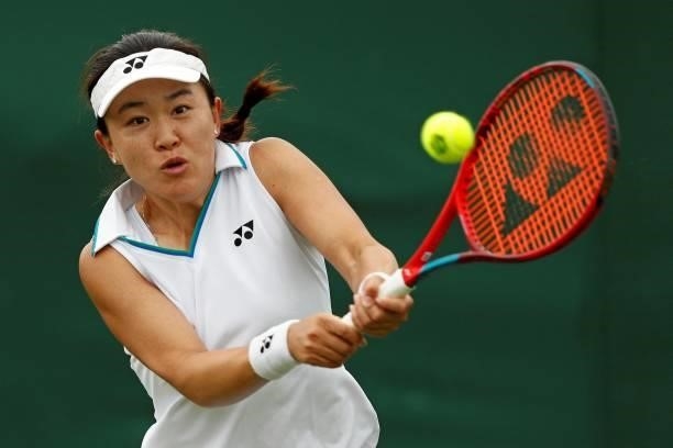 China's Lin Zhu returns against Germany's Mona Barthel during their women's singles first round match on the second day of the 2021 Wimbledon...