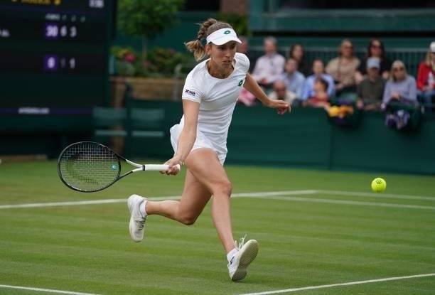 Belgium's Elise Mertens returns to Britain's Harriet Dart during their women's singles first round match on the second day of the 2021 Wimbledon...
