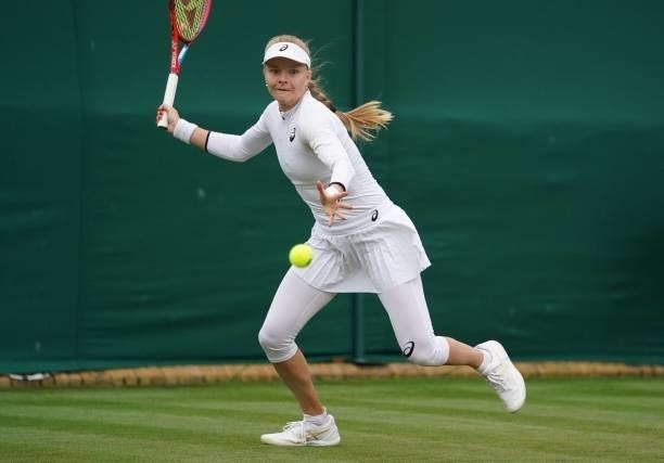 Britain's Harriet Dart returns to Belgium's Elise Mertens during their women's singles first round match on the second day of the 2021 Wimbledon...
