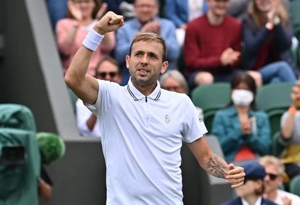 Britain's Daniel Evans celebrates his victory over Spain's Feliciano Lopez during their men's singles first round match on the second day of the 2021...