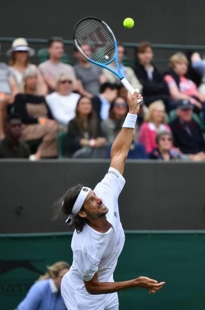 Spain's Feliciano Lopez serves to Britain's Daniel Evans during their men's singles first round match on the second day of the 2021 Wimbledon...