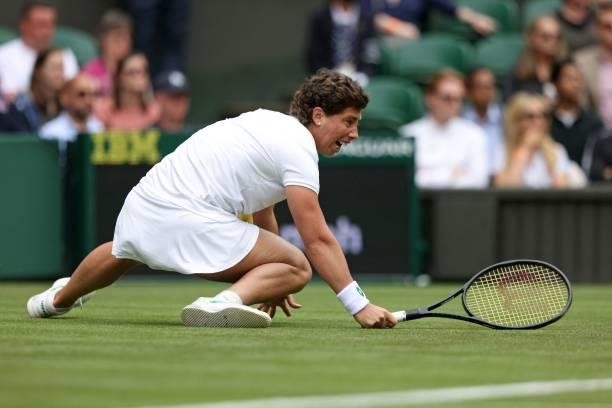 Spain's Carla Suarez Navarro slips on the grass as she tries to return against Australia's Ashleigh Barty during their women's singles first round...