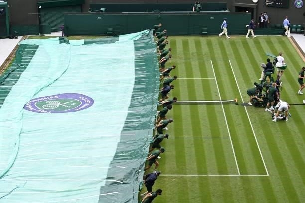 The covers are pulled on court 1 as rain stops play between Netherland's Tallon Griekspoor and Germany's Alexander Zverev in their men's singles...