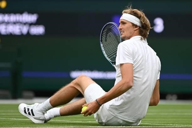 Germany's Alexander Zverev falls while playing Netherland's Tallon Griekspoor during their men's singles first round match on the second day of the...