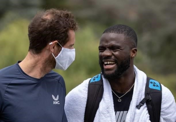 Britain's Andy Murray speaks with US player Frances Tiafoe on the Aorangi Practice Courts during the second day of the 2021 Wimbledon Championships...