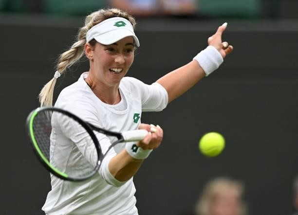 Serbia's Nina Stojanovic returns to Germany's Angelique Kerber during their women's singles first round match on the second day of the 2021 Wimbledon...