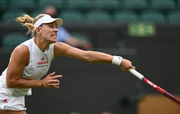 Germany's Angelique Kerber serves to Serbia's Nina Stojanovic during their women's singles first round match on the second day of the 2021 Wimbledon...