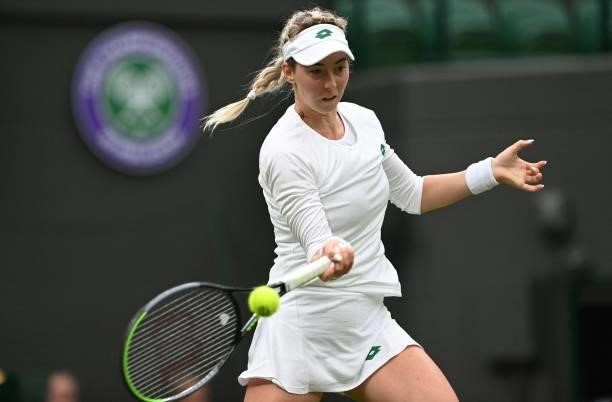 Serbia's Nina Stojanovic returns to Germany's Angelique Kerber during their women's singles first round match on the second day of the 2021 Wimbledon...