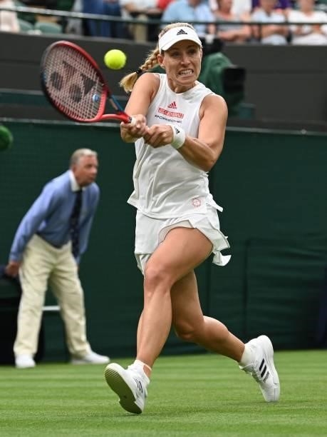 Germany's Angelique Kerber returns to Serbia's Nina Stojanovic during their women's singles first round match on the second day of the 2021 Wimbledon...